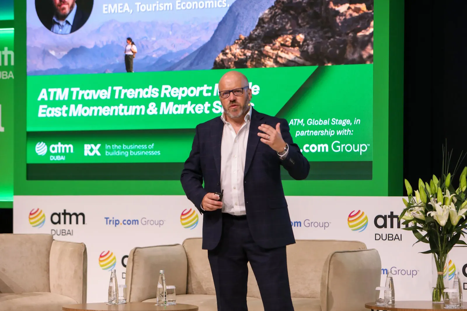 Dave Goodger presenting travel research findings on stage