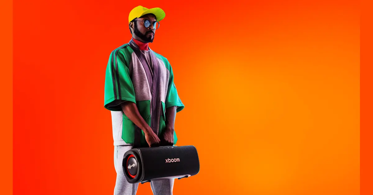 LG xboom Blast portable Bluetooth speaker shown outdoors on a table